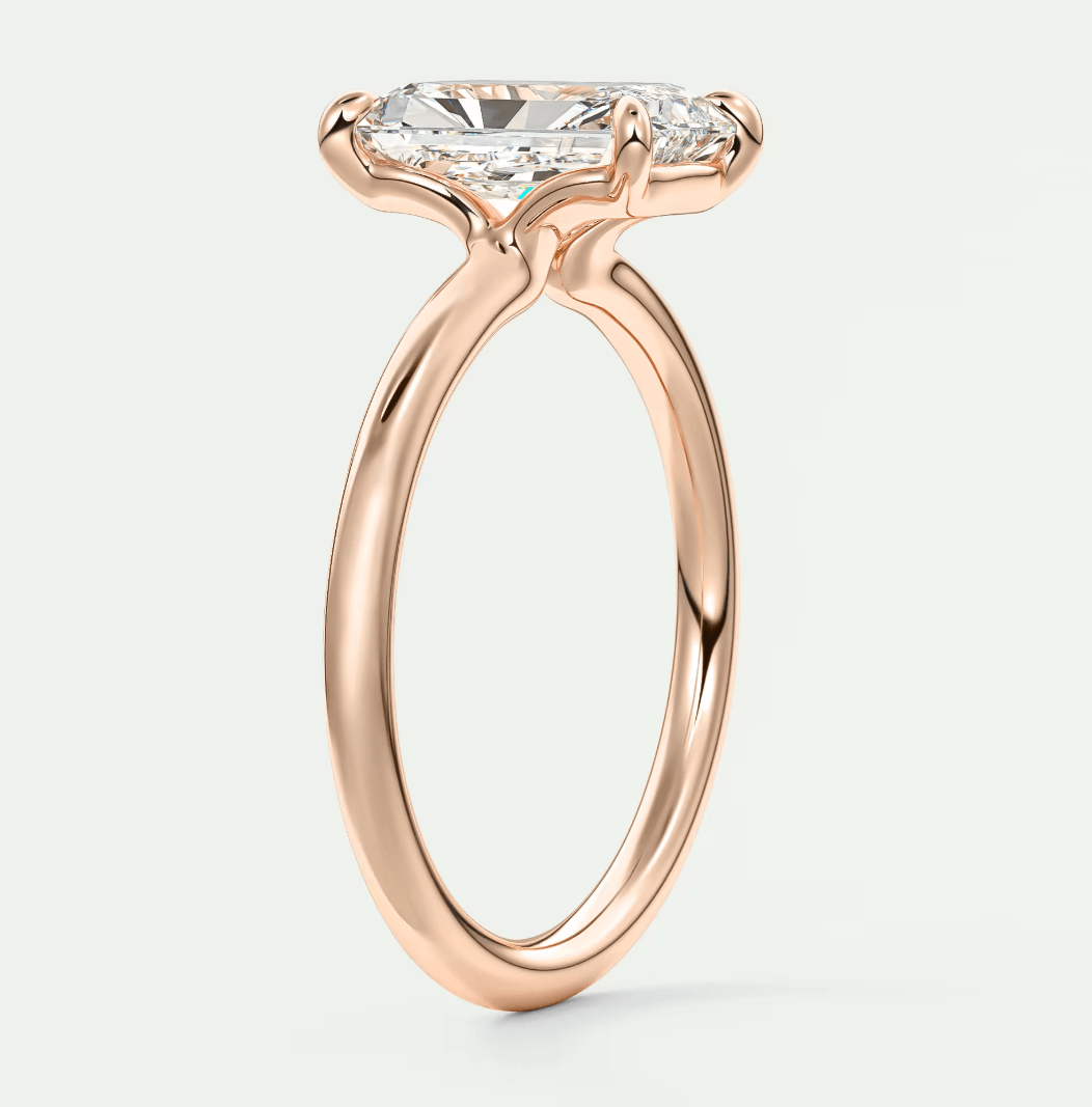 Rose gold engagement ring with a princess cut diamond.