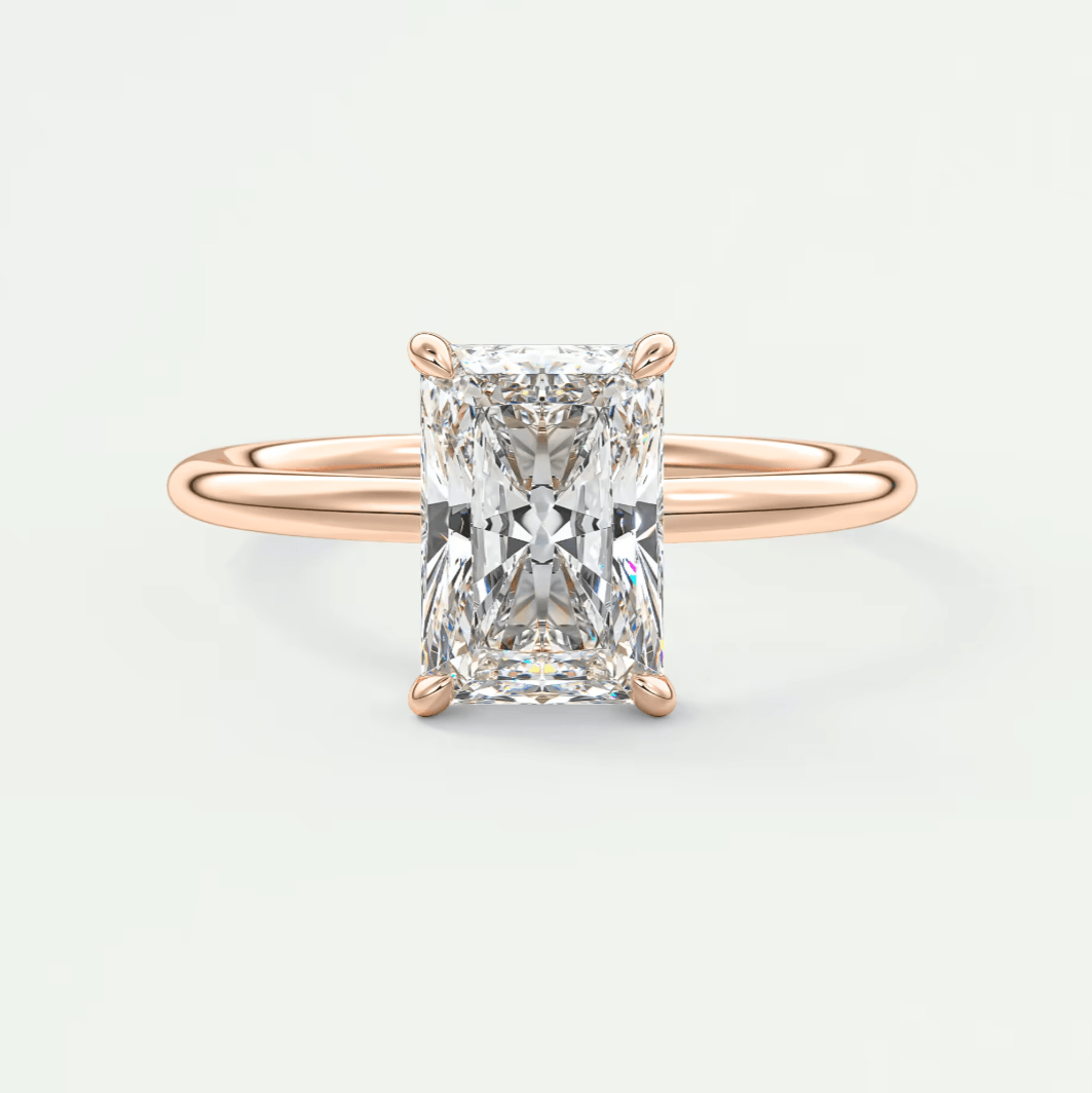 18k rose gold diamond engagement ring with an emerald cut stone.