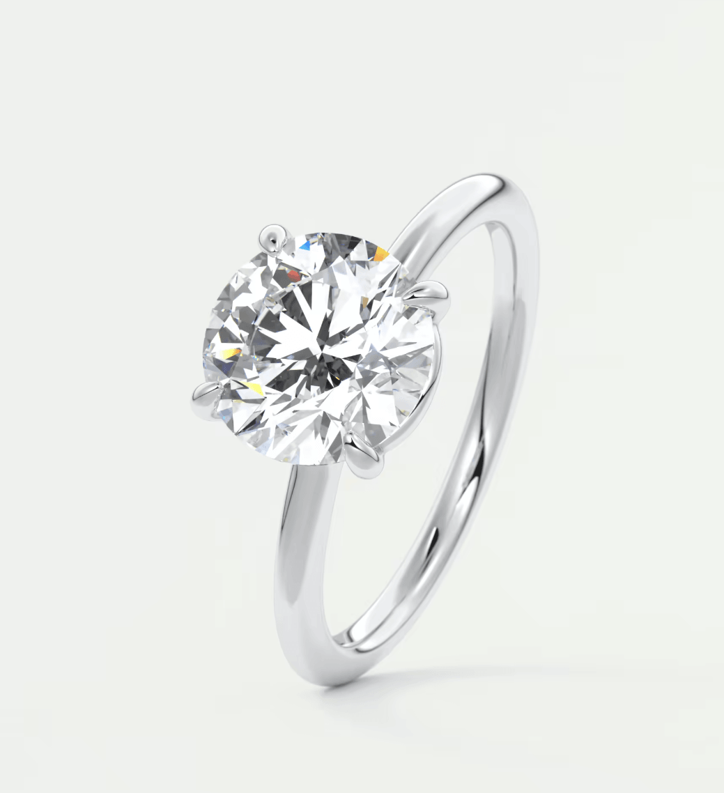 18-karat white gold solitaire diamond engagement ring.