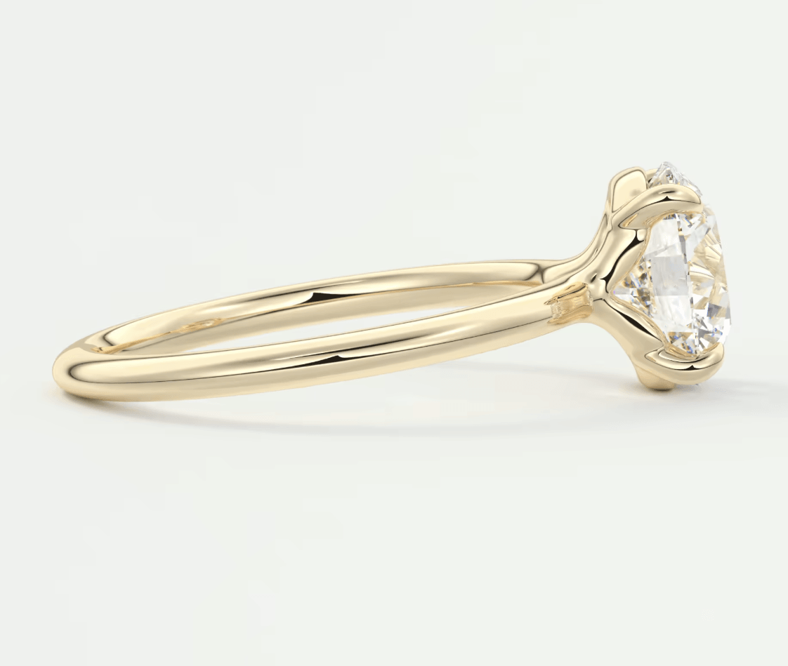 18k yellow gold engagement ring with a round diamond.