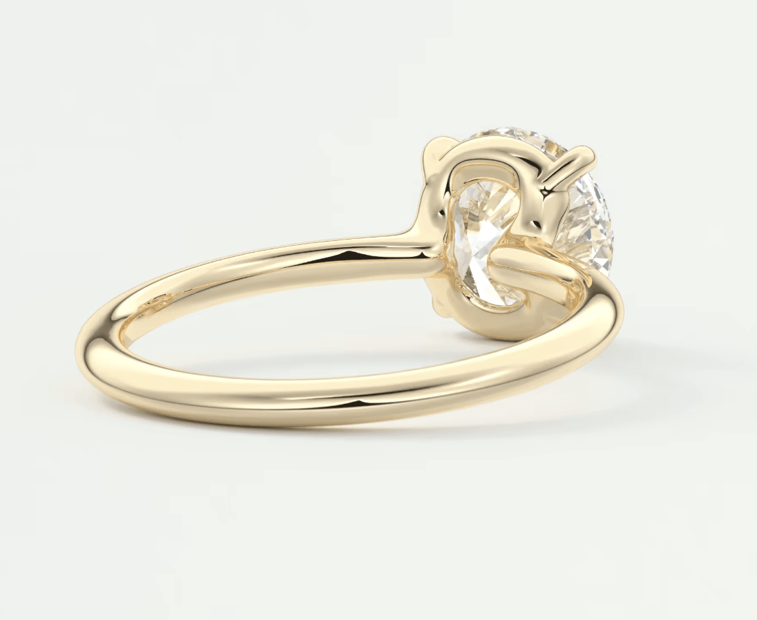 18k yellow gold engagement ring with a round diamond and small accent stone.