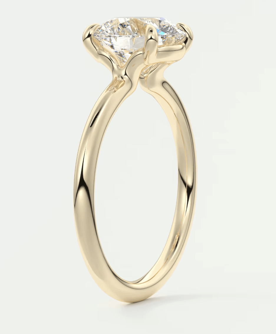 18-karat yellow gold engagement ring with a round diamond.