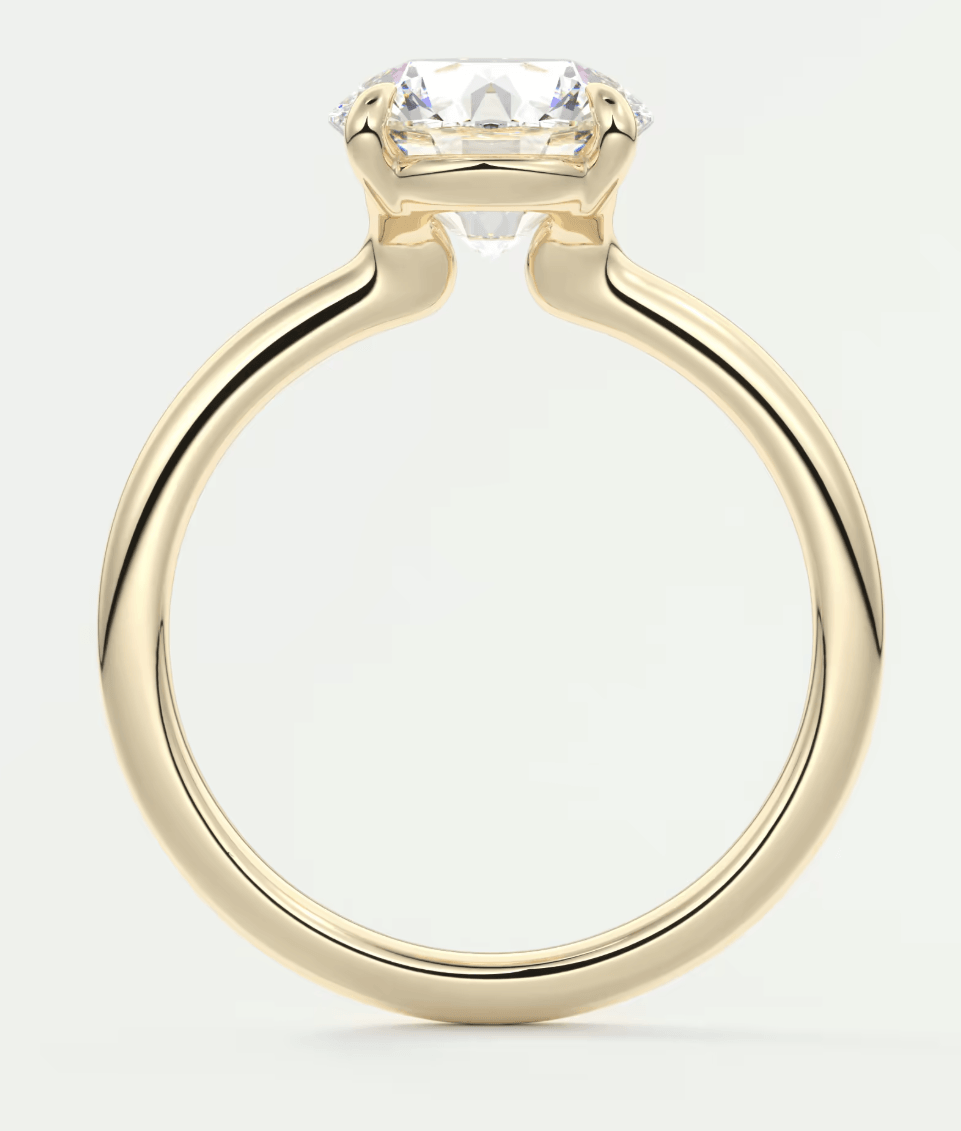 18k yellow gold engagement ring with a cushion-cut diamond.