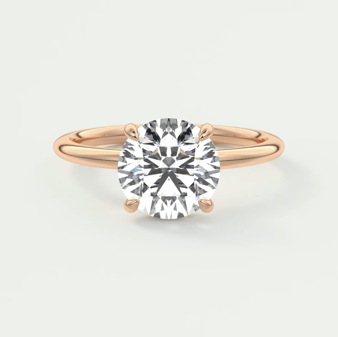 18k rose gold engagement ring with a cushion-cut diamond.