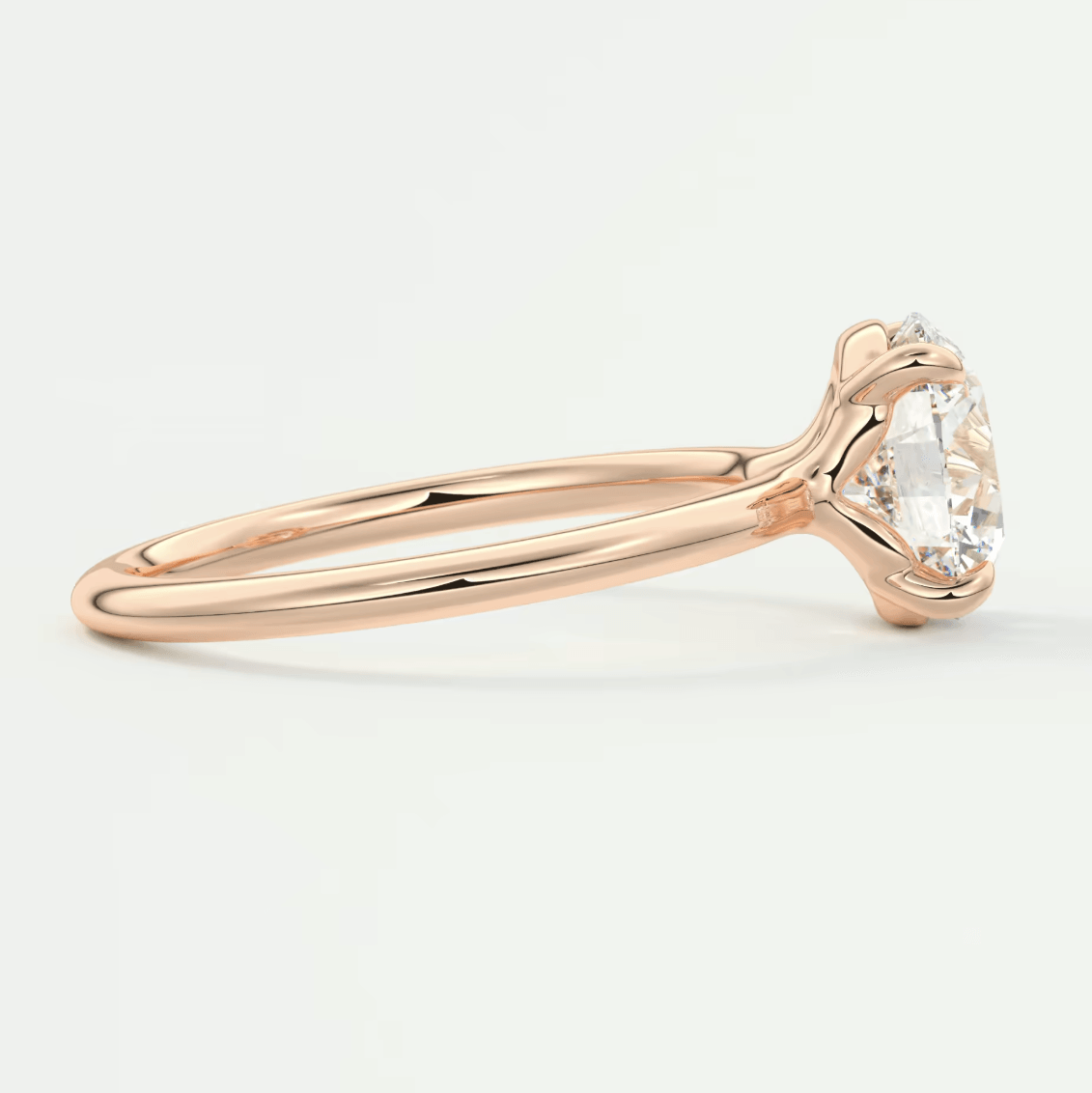 18-karat rose gold engagement ring with a cushion-cut diamond.