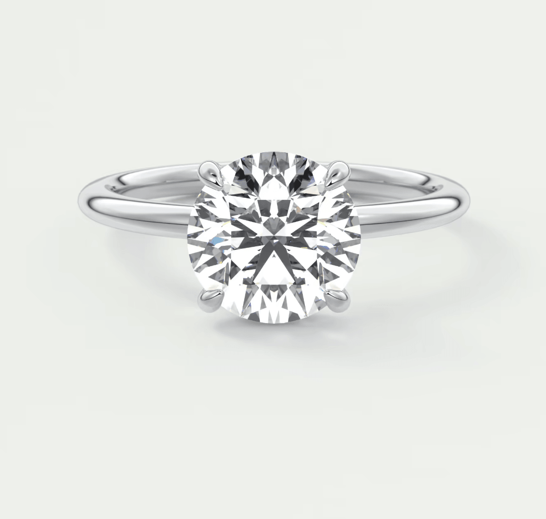 White gold solitaire diamond engagement ring with a round brilliant cut gemstone.