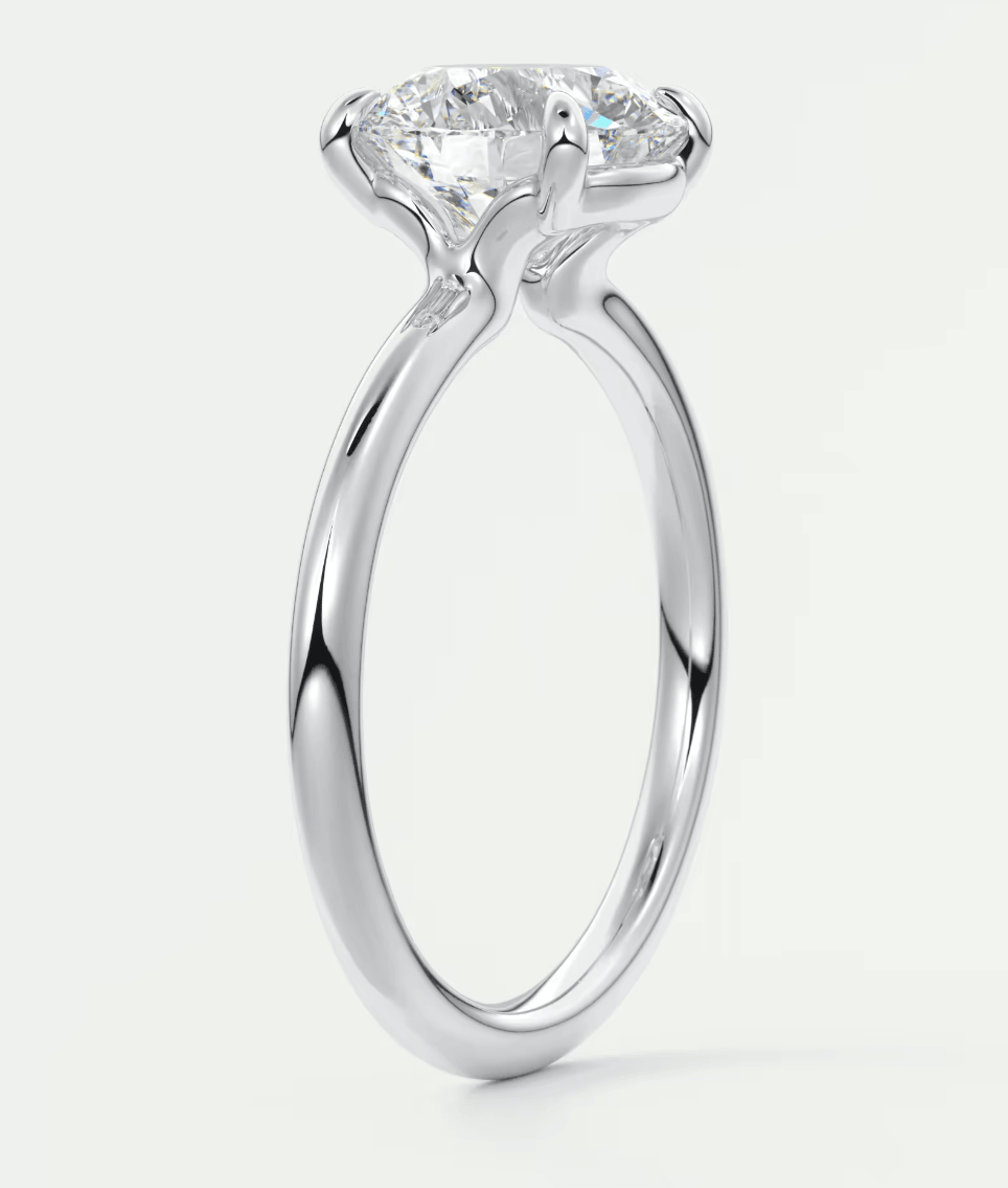 18-karat white gold solitaire engagement ring with a round diamond.