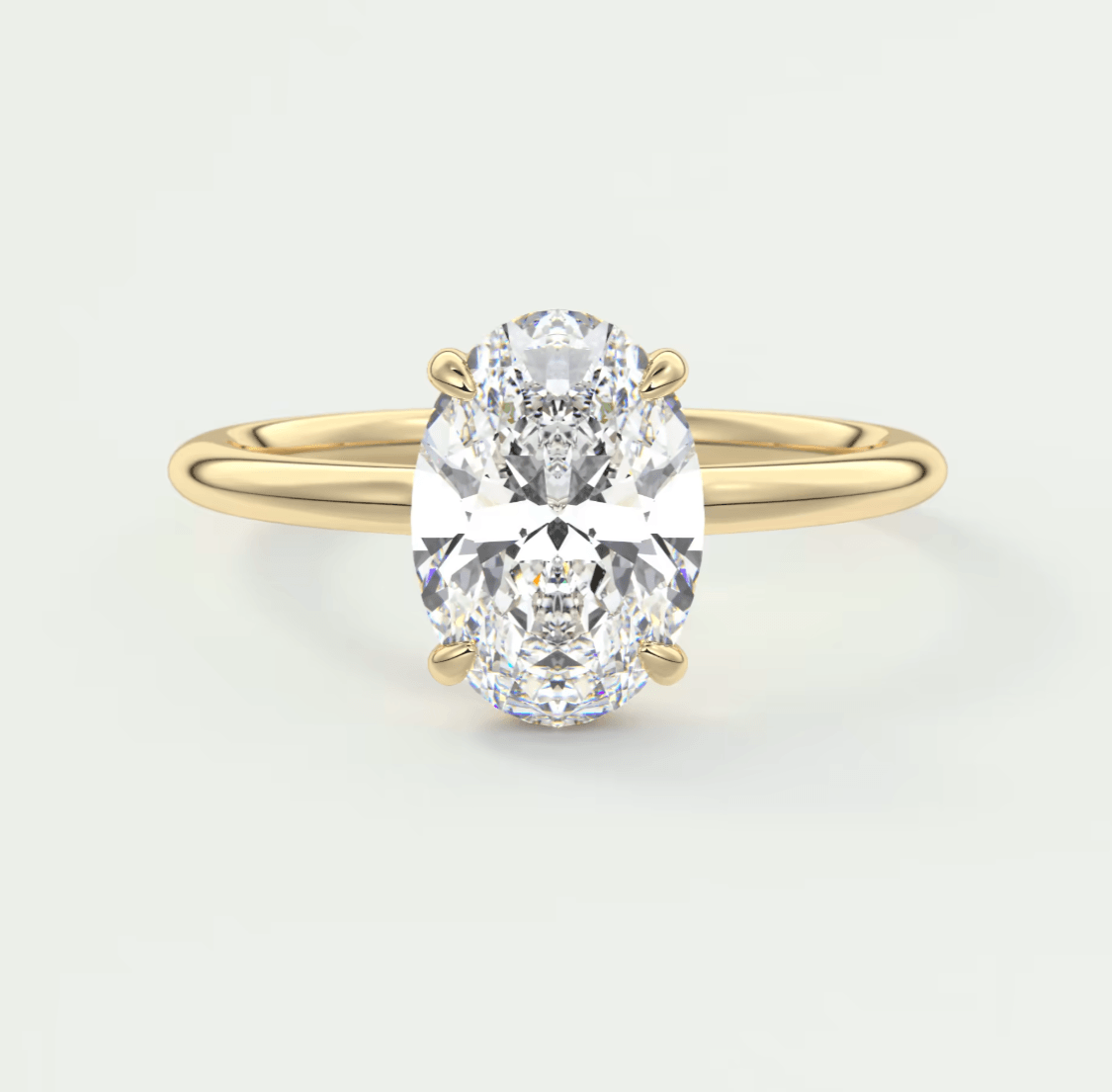 18-karat yellow gold oval diamond engagement ring.