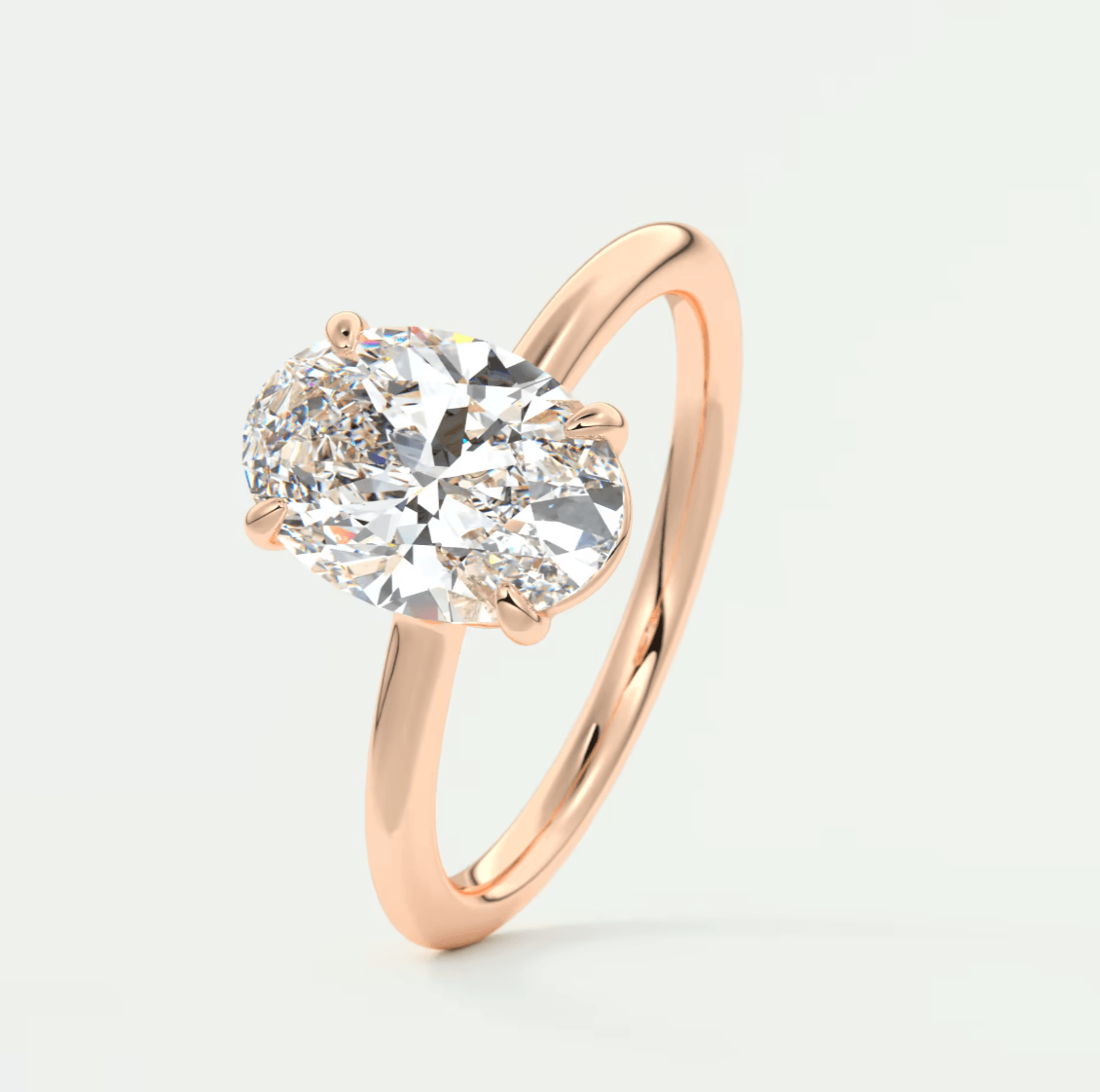 18k rose gold diamond engagement ring with a round-cut center stone.
