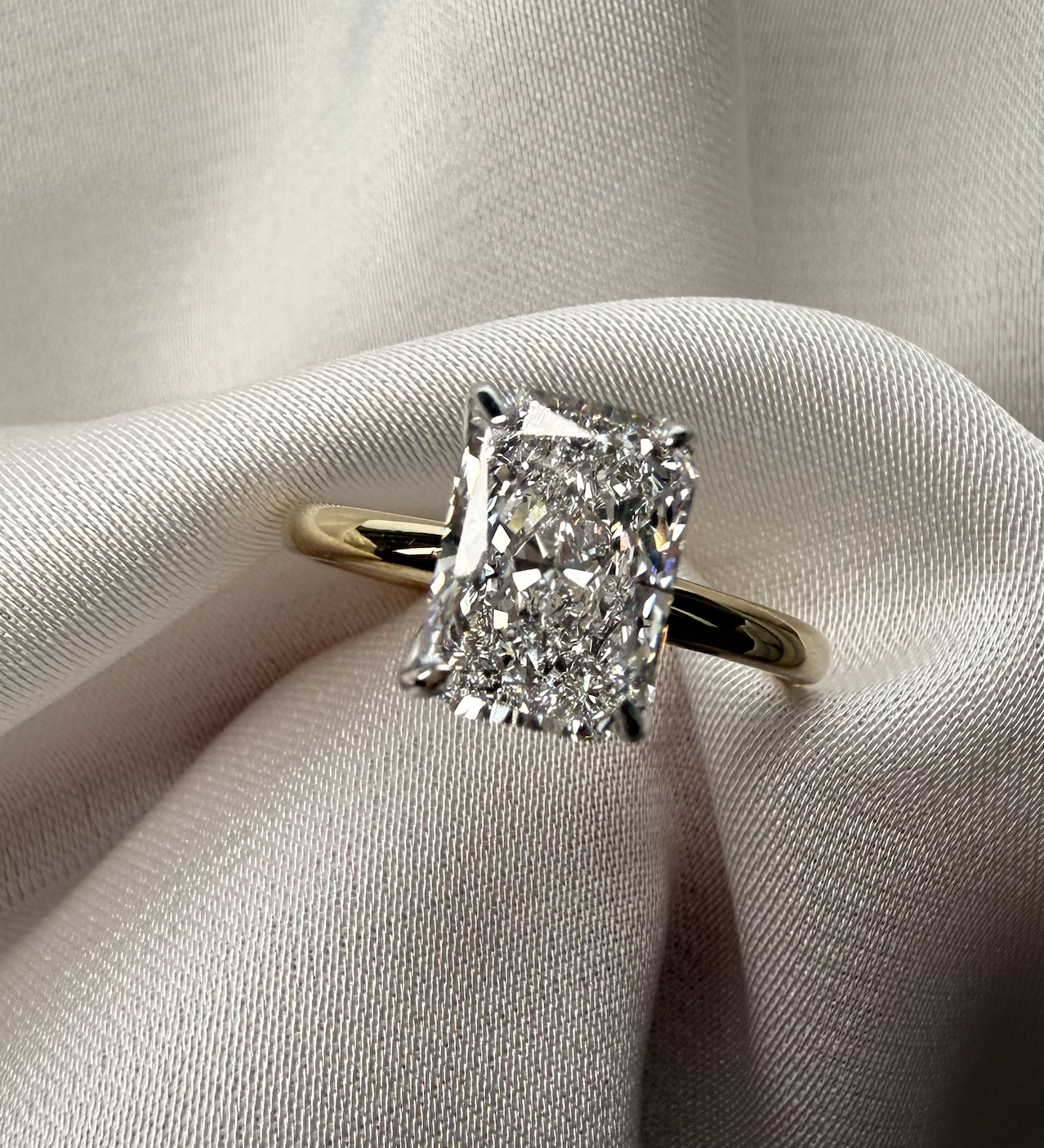 Diamond ring on a soft fabric background