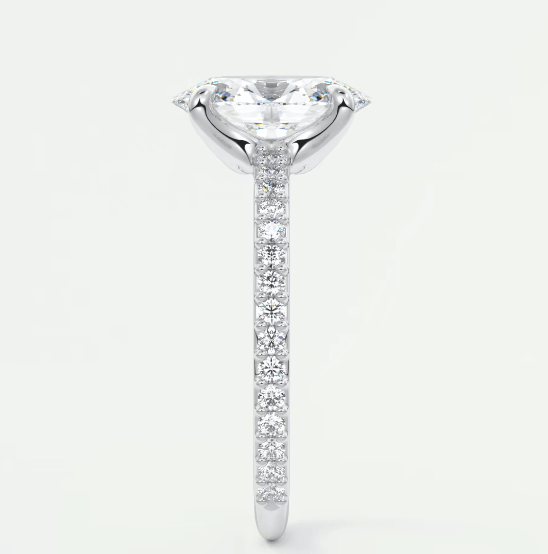 18-karat white gold engagement ring with a marquise-cut diamond and pavé-set diamonds on the band.