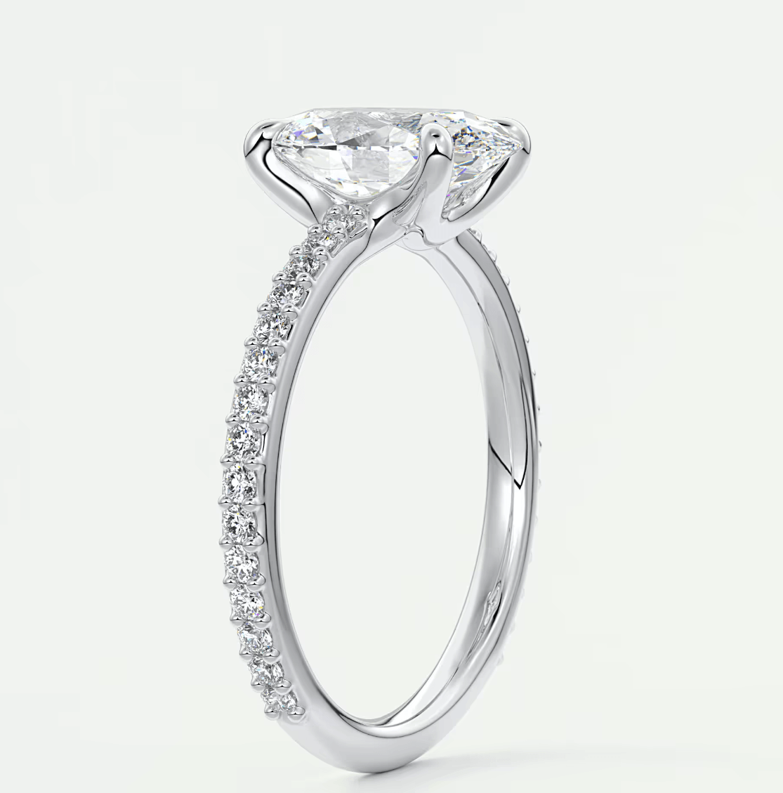 18-karat white gold engagement ring with a princess-cut diamond and pavé-set diamonds on the band.