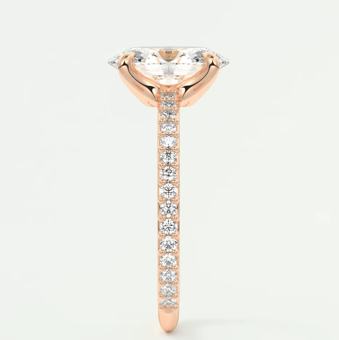 18-karat rose gold engagement ring with a marquise-cut diamond and pavé side stones.
