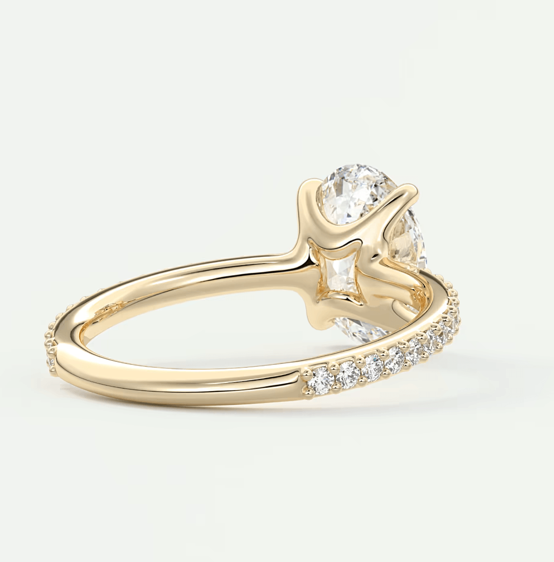 18k yellow gold engagement ring with a diamond center stone and pave set diamonds on the band.