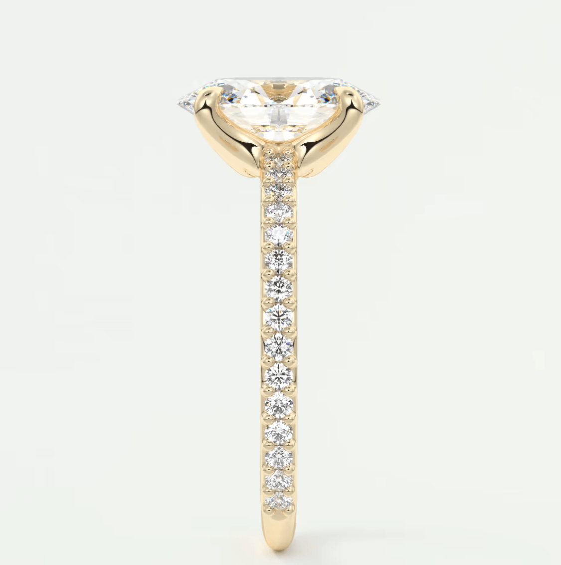 18k yellow gold engagement ring with a marquise-cut diamond and pave-set diamonds on the band.