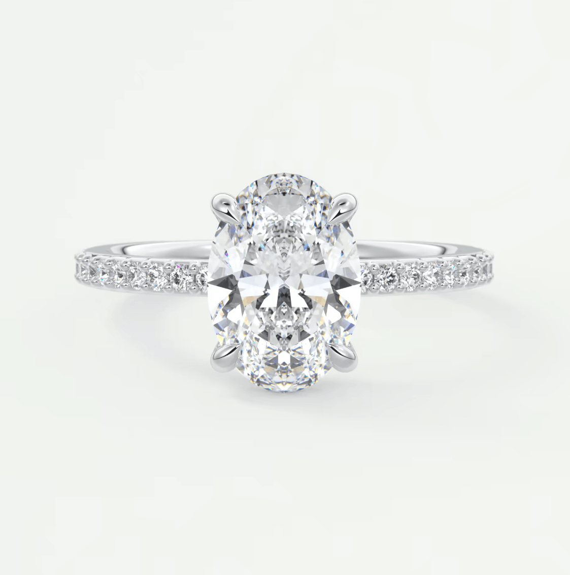 18k white gold oval diamond engagement ring with a halo of smaller diamonds.