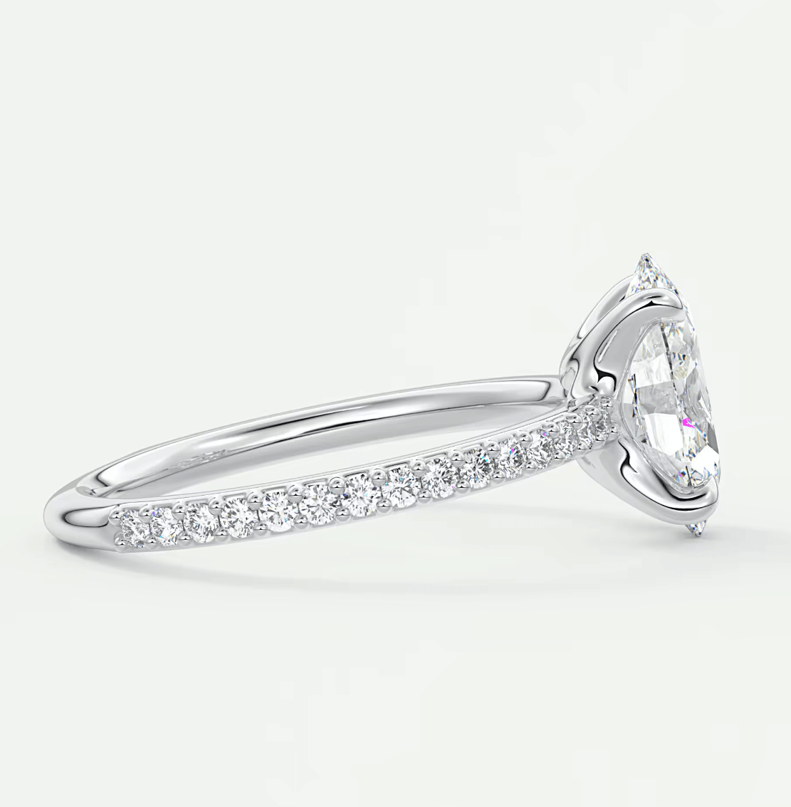 18k white gold diamond engagement ring with a marquise-cut center stone and pave-set diamonds on the band.