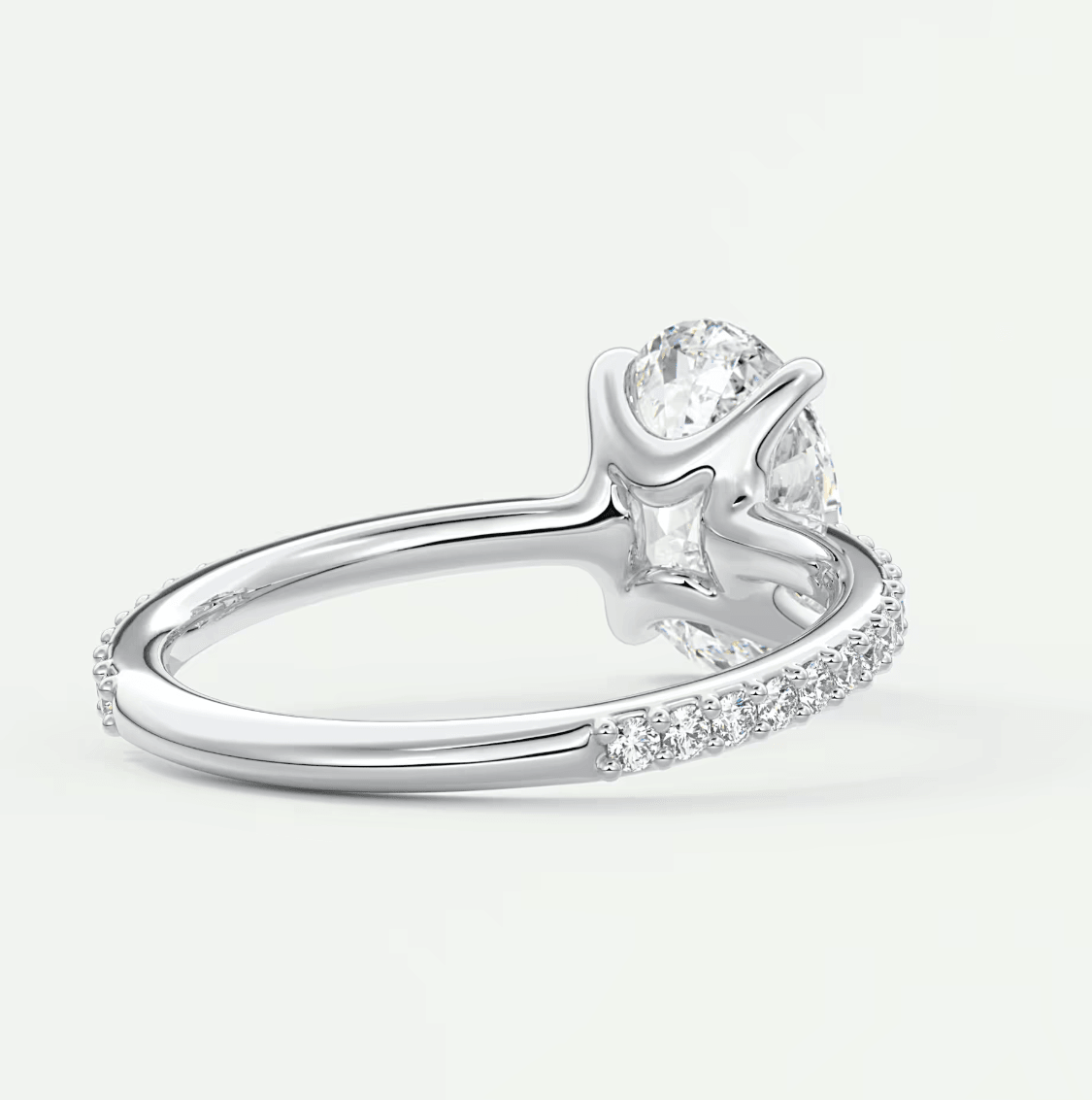 18k white gold diamond engagement ring with a pear-shaped center stone and round side stones.