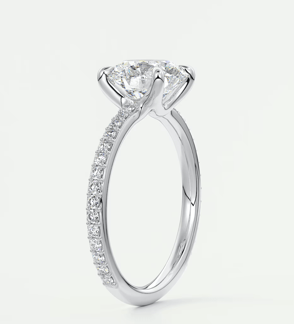 18k white gold diamond engagement ring with a round brilliant cut center stone and pave set diamonds on the band.