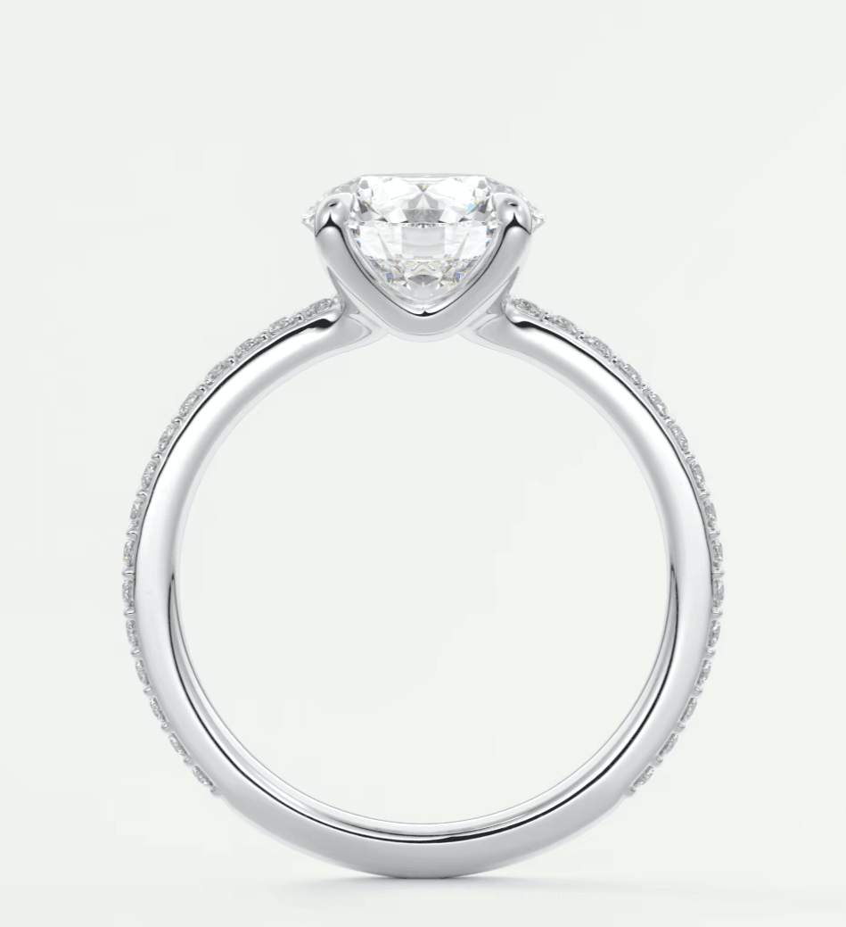 18k white gold engagement ring with a round diamond center stone and milgrain detailing.