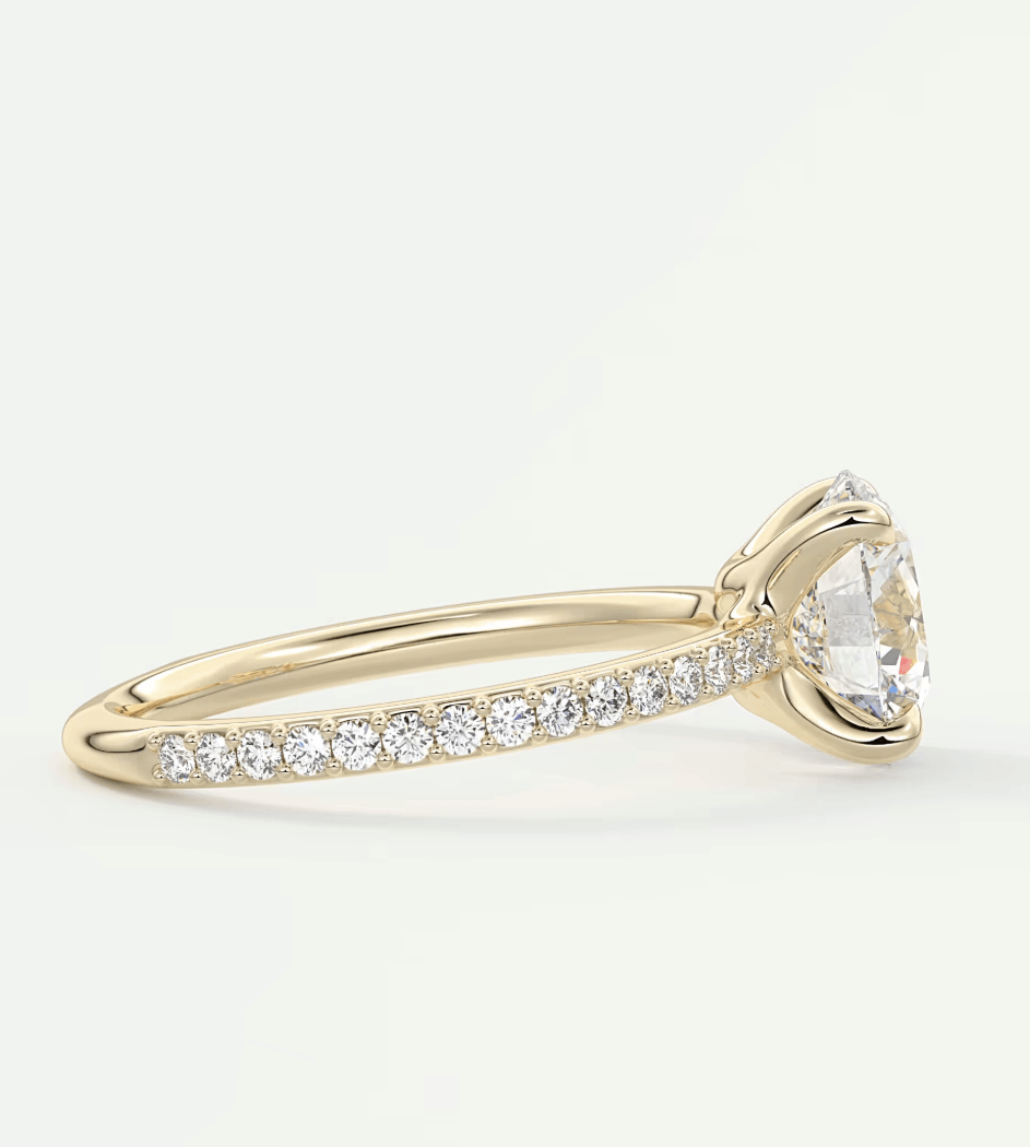 18k yellow gold diamond engagement ring with a marquise-cut center stone and pave-set diamonds on the band.