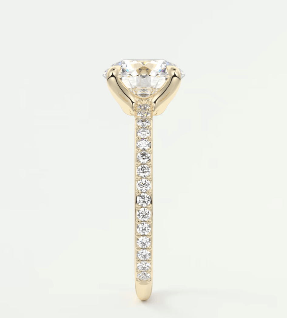 18k yellow gold diamond engagement ring with a round brilliant cut center stone and channel set diamonds on the band.