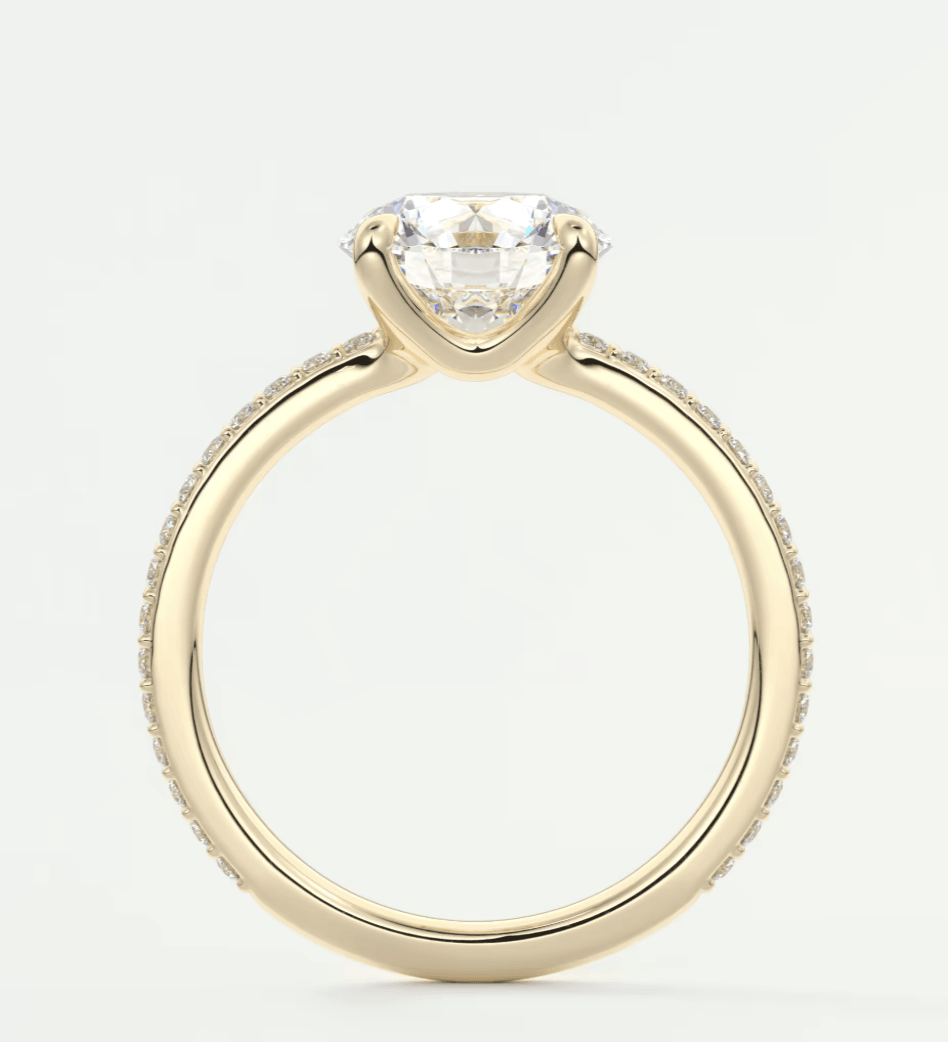 18-karat yellow gold engagement ring with a round diamond center stone and pave-set diamonds on the band.