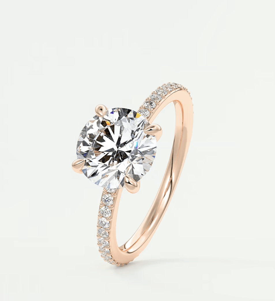 Rose gold diamond engagement ring with a round-cut center stone and pave-set diamonds on the band.