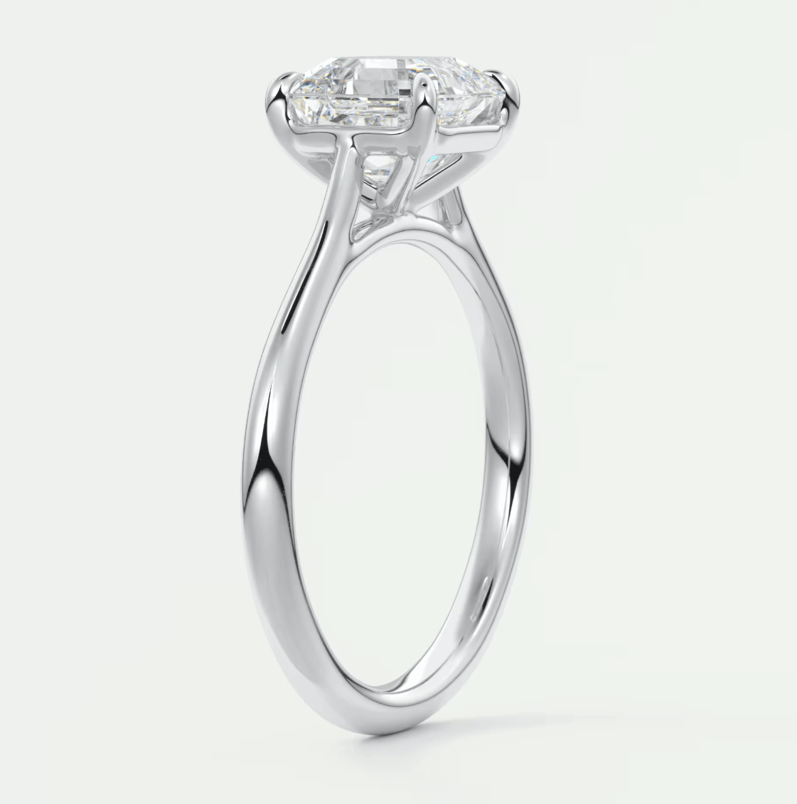 White gold engagement ring with a princess cut diamond and four prongs.