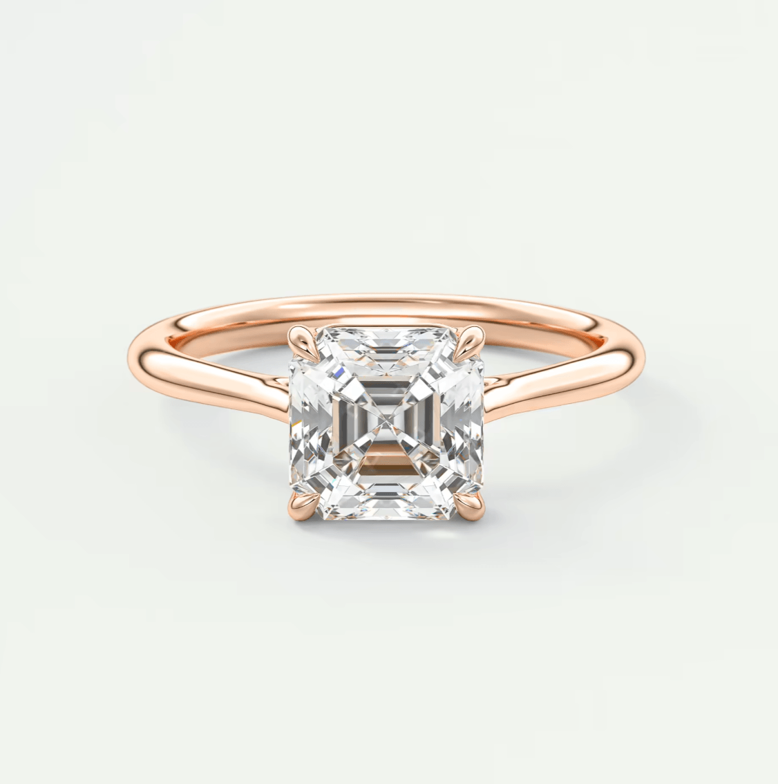 18-karat rose gold engagement ring with a princess-cut diamond.