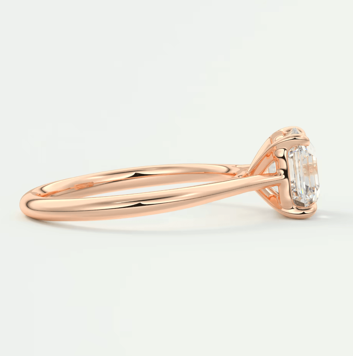 18-karat rose gold engagement ring with an emerald-cut diamond.
