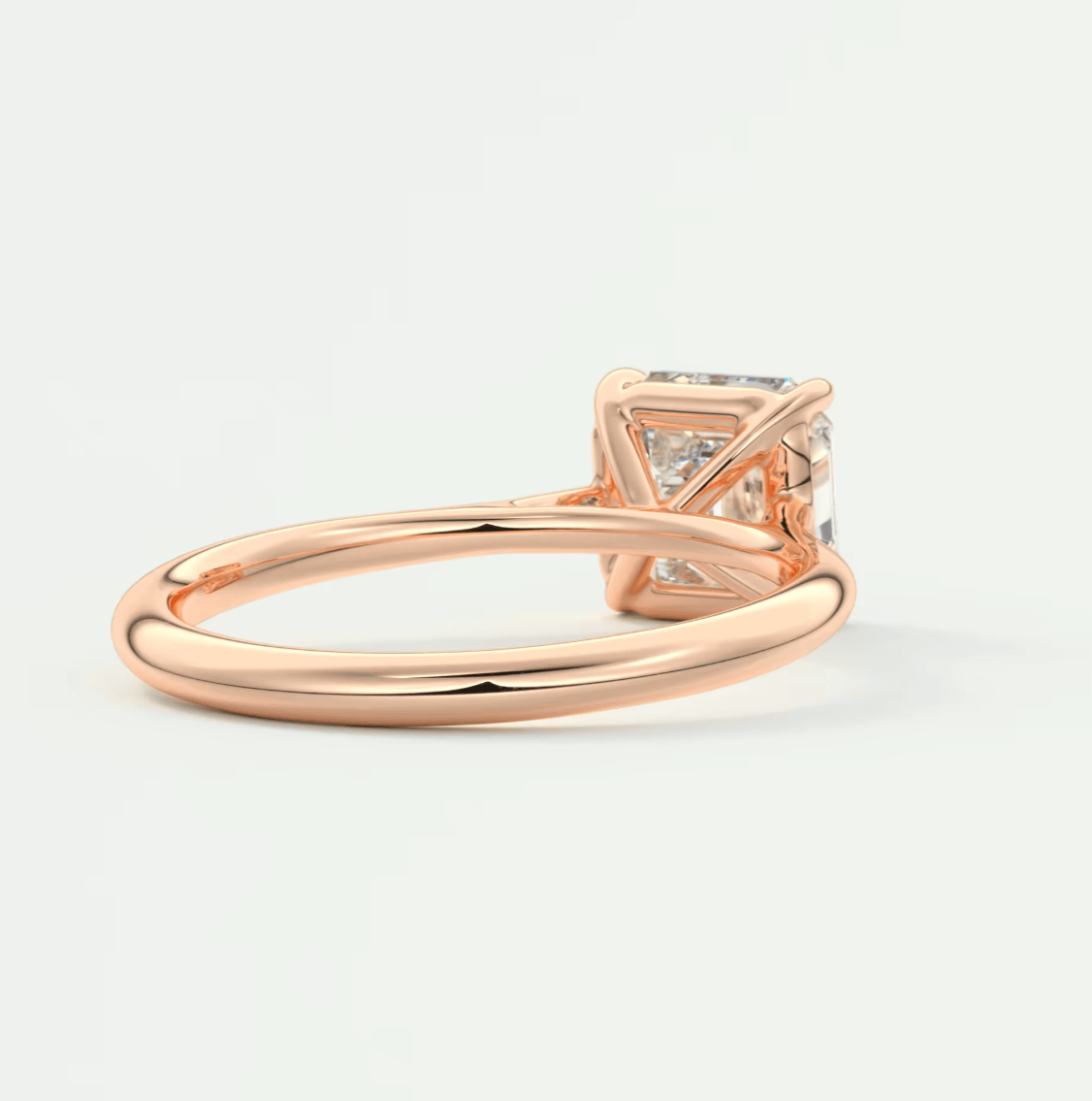 18-karat rose gold princess-cut diamond engagement ring.