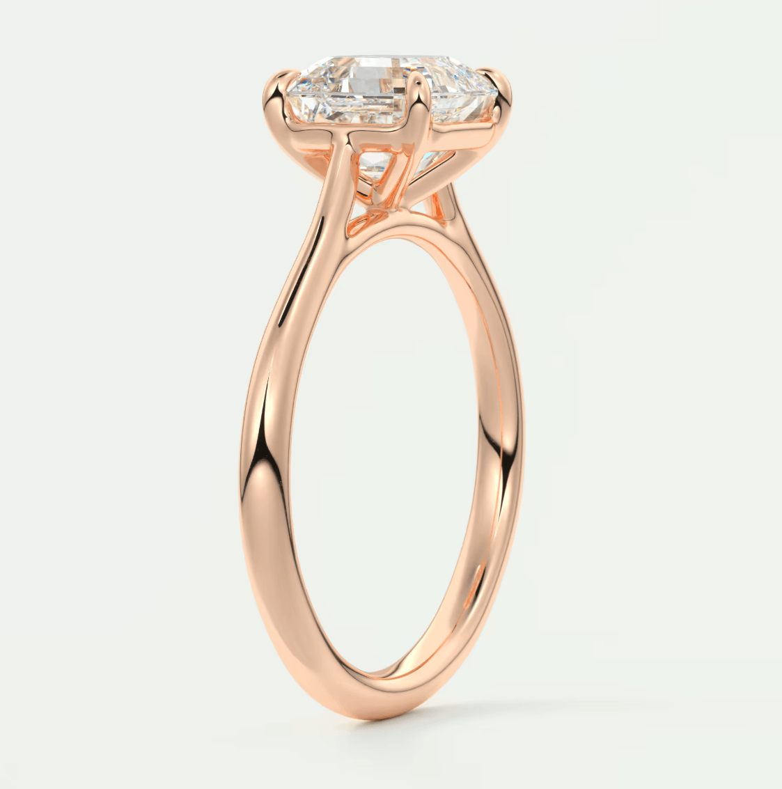 Rose gold engagement ring with princess cut diamond and side stones