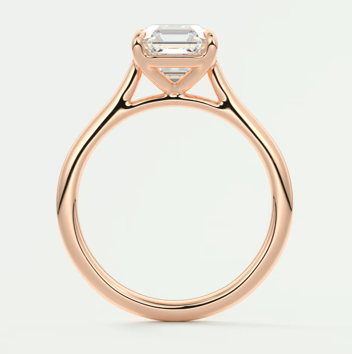 18-karat rose gold engagement ring with an emerald-cut diamond.