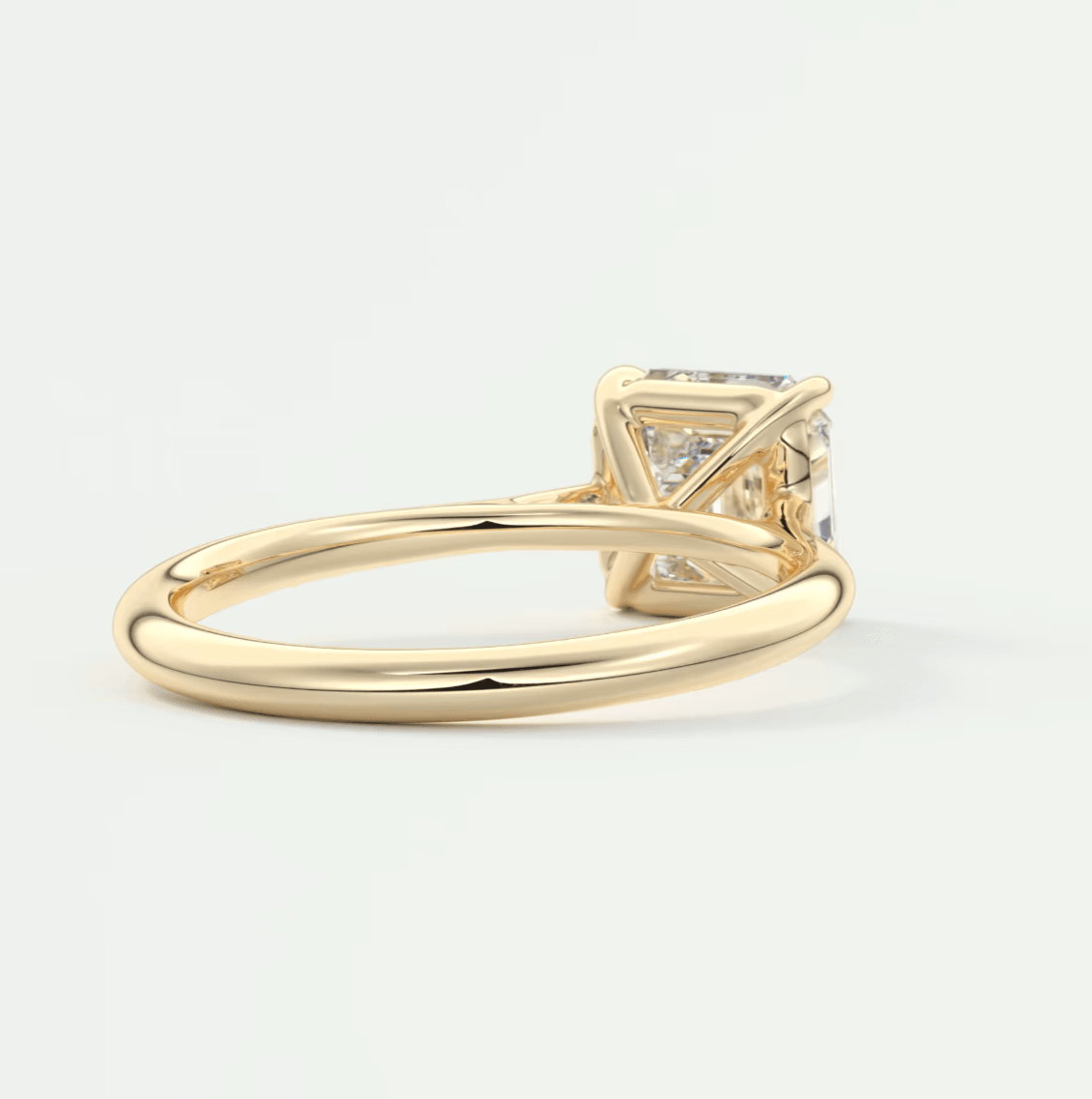 18-karat yellow gold engagement ring with a princess-cut diamond.