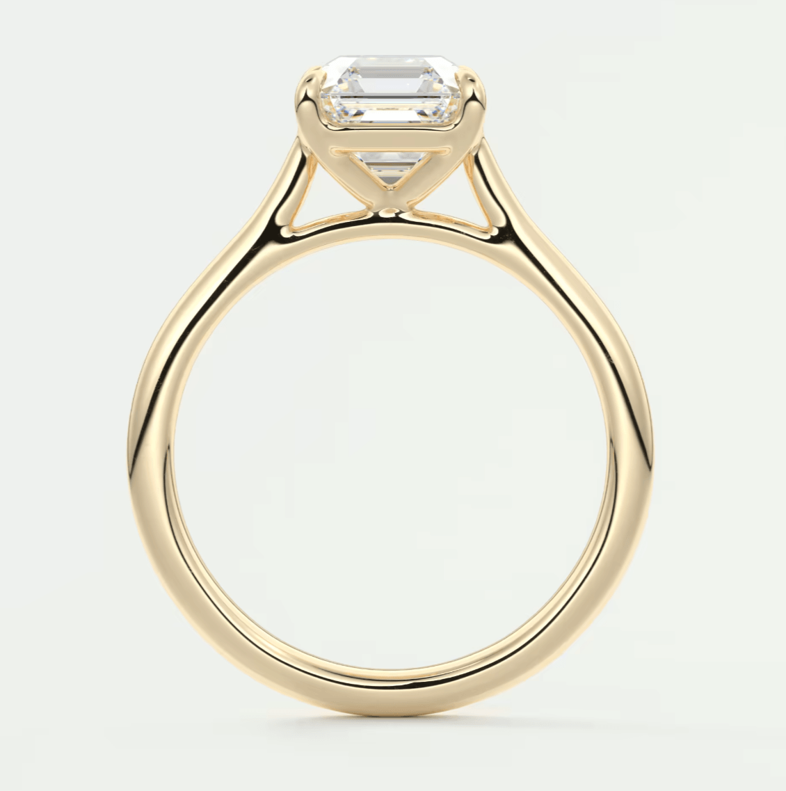 18k yellow gold engagement ring with an emerald-cut diamond.