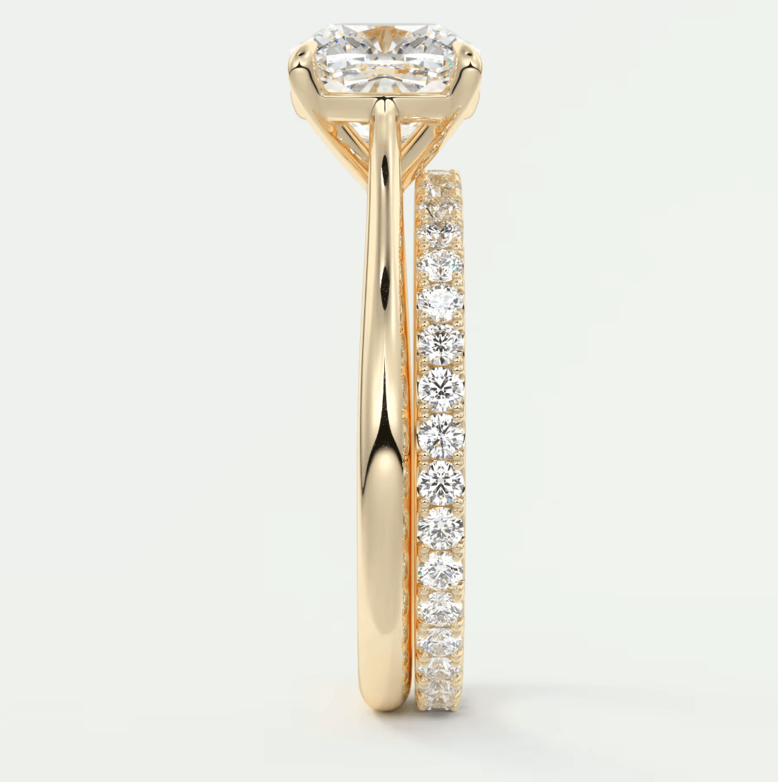 18k yellow gold diamond engagement ring with a cushion-cut center stone and pavé set diamonds on the band.