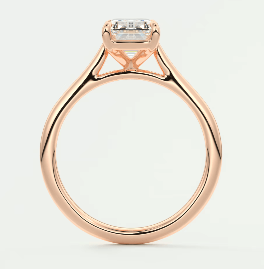 18-karat rose gold engagement ring with a princess-cut diamond.