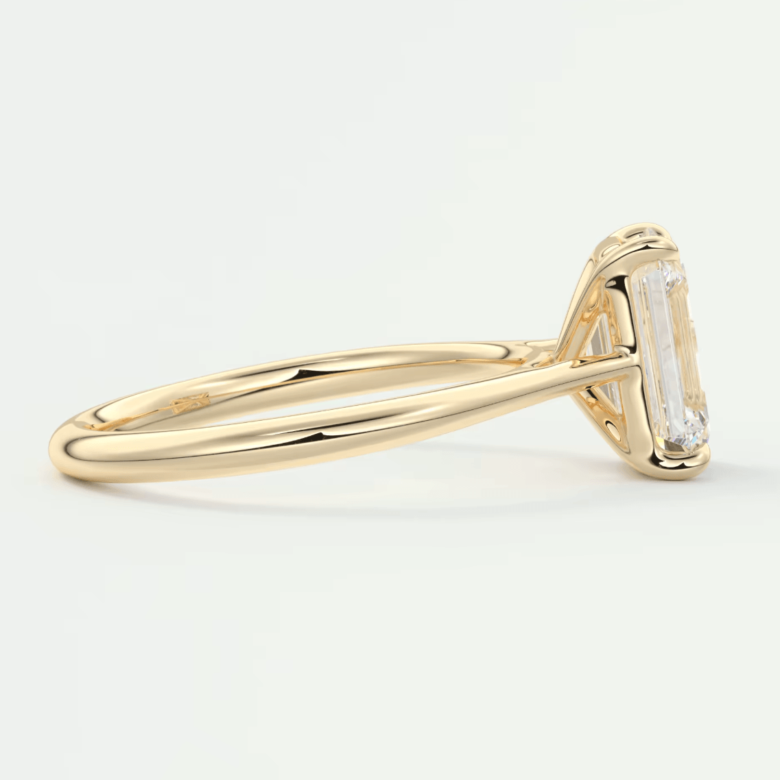 18k yellow gold emerald-cut diamond engagement ring.