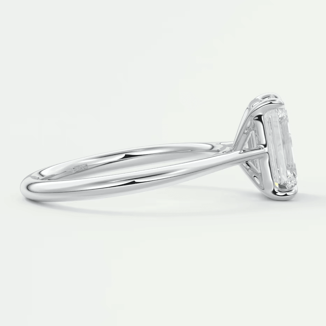 18k white gold engagement ring with an emerald-cut diamond.