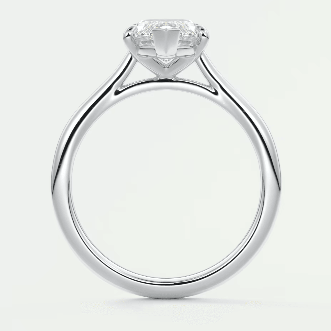 18-karat white gold solitaire engagement ring with a cushion-cut diamond.