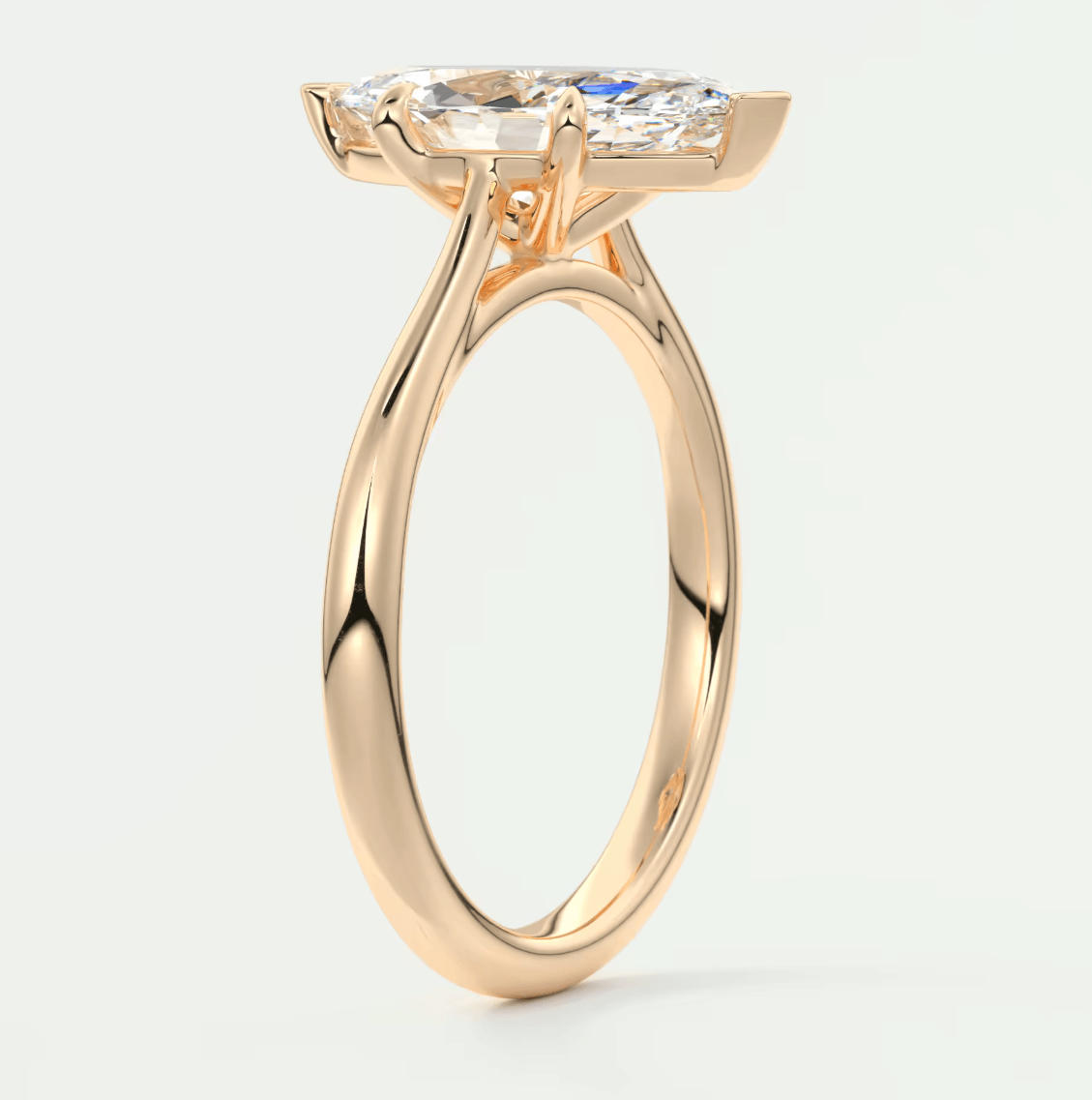 18-karat rose gold engagement ring with a marquise-cut diamond.