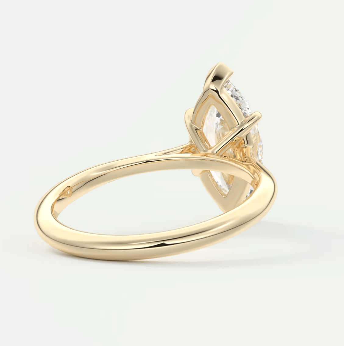 18-karat yellow gold engagement ring with a marquise-cut diamond.