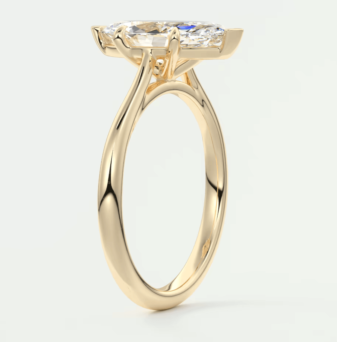 18-karat yellow gold engagement ring with a marquise-cut diamond.