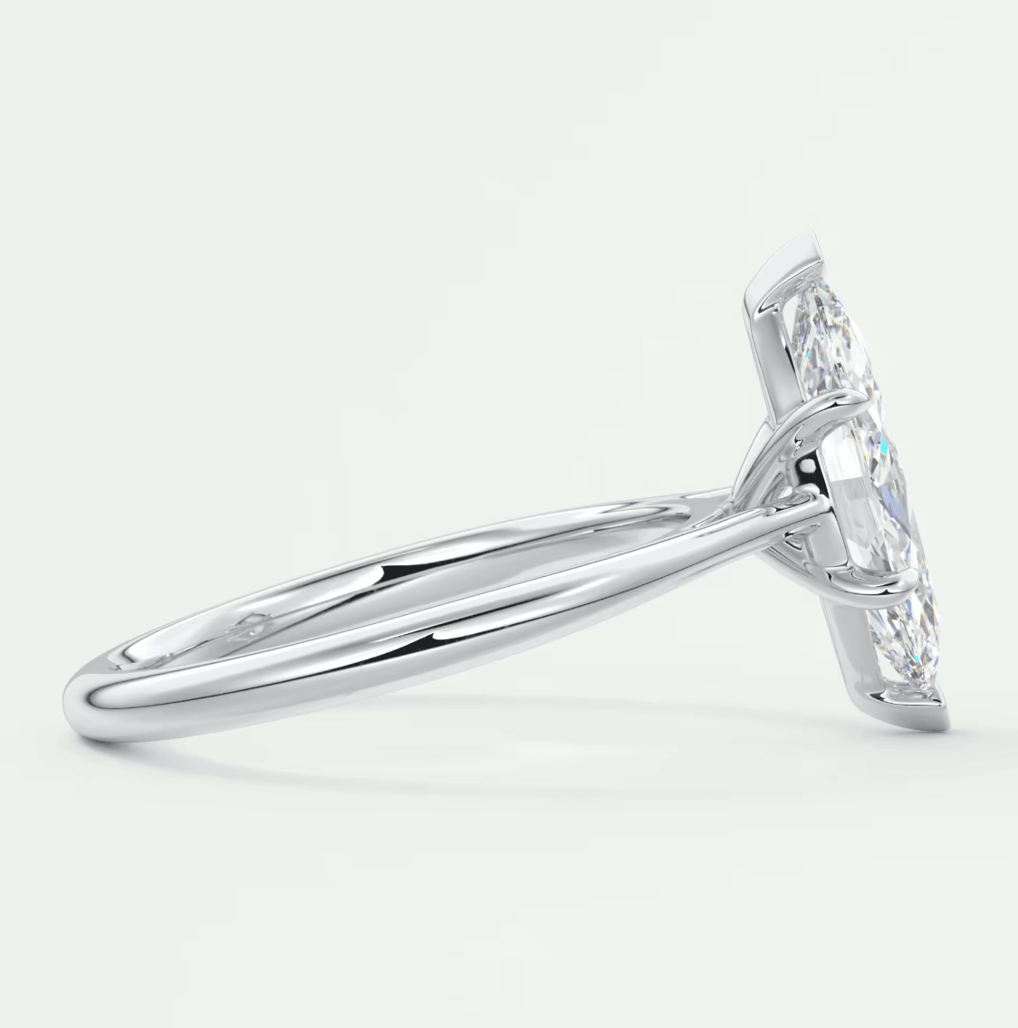 18k white gold diamond engagement ring with a marquise-cut center stone and small diamonds on the band.
