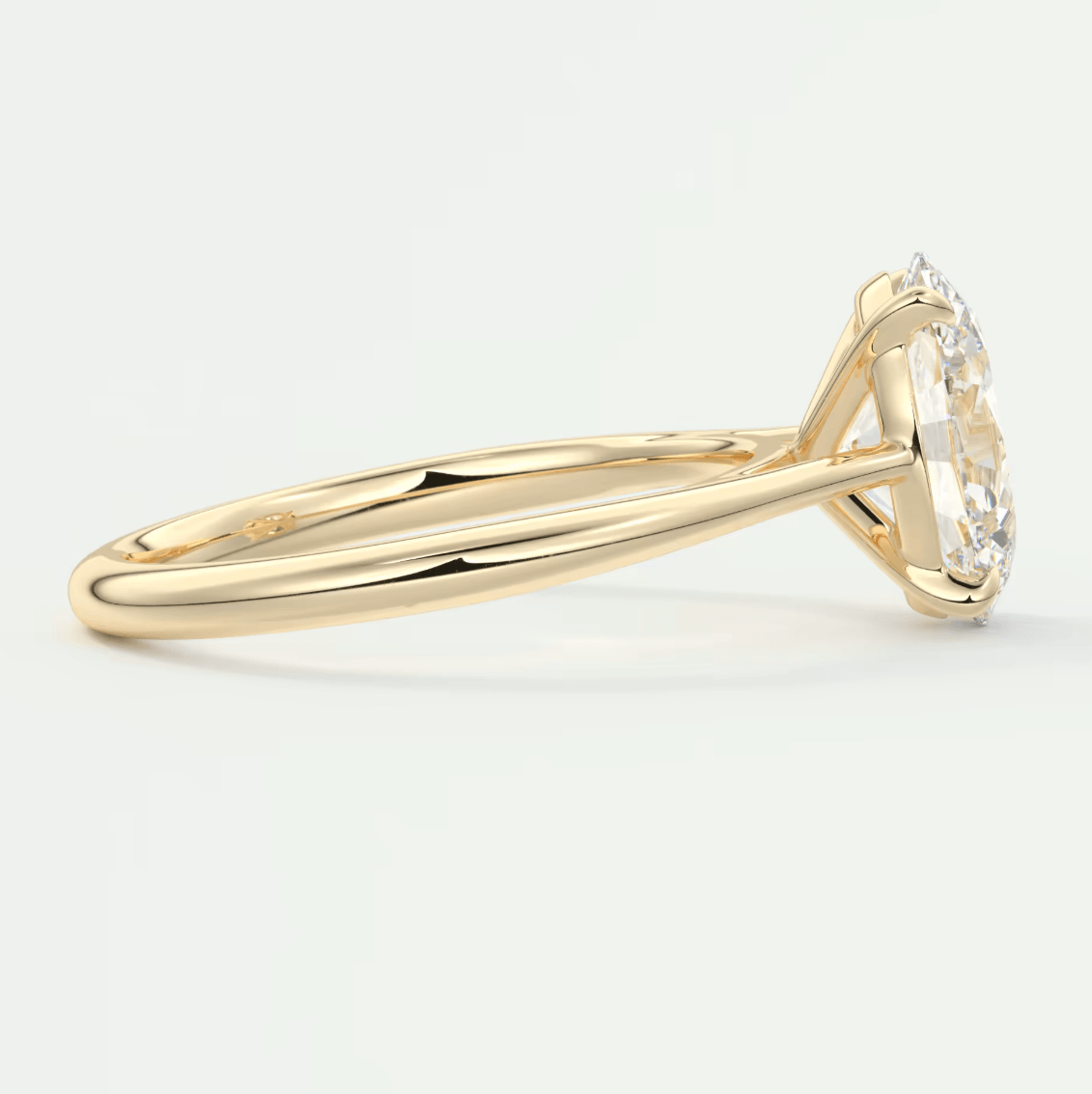 18k yellow gold diamond engagement ring with a halo setting.