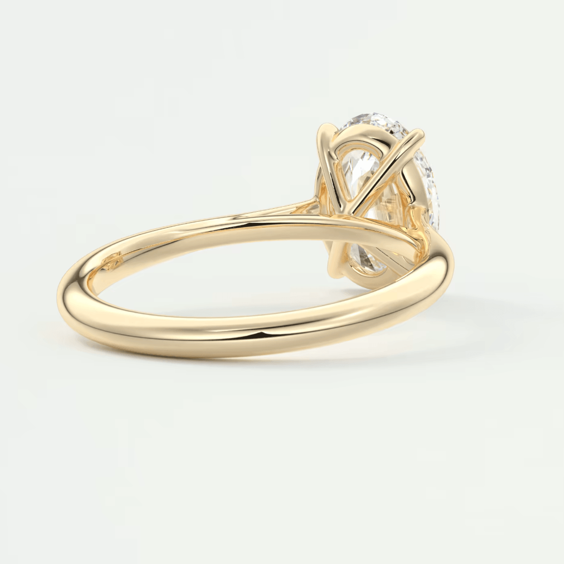 18-karat gold engagement ring with a large, round diamond.