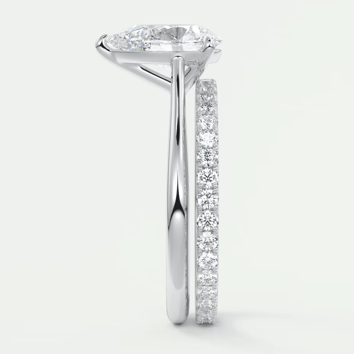 White gold diamond engagement ring set with a princess cut center stone and channel-set side stones.