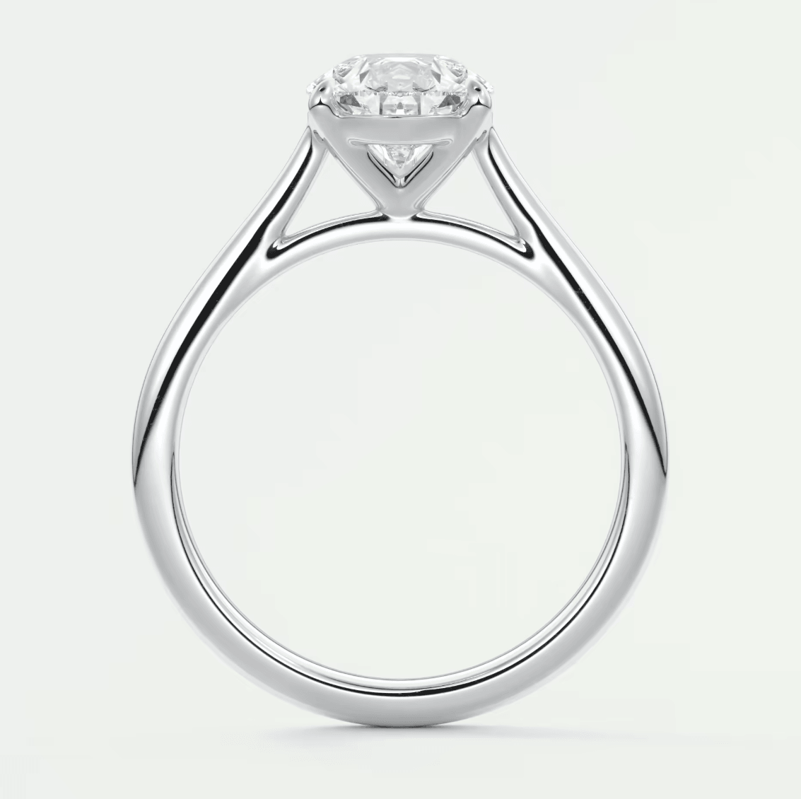 White gold solitaire diamond engagement ring with a round-cut stone.