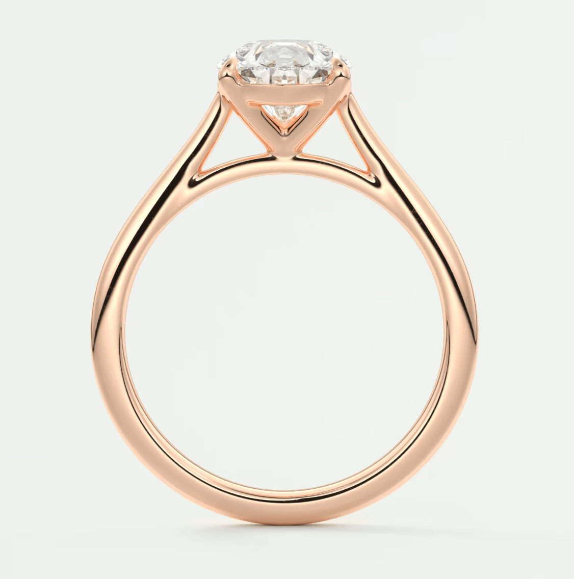 18-karat rose gold engagement ring with a round diamond.
